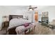 Bedroom with wood-look floors, a king bed, and view into ensuite bathroom at 3880 Sw 6Th Ave, Ocala, FL 34471