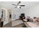 Bedroom with a ceiling fan, an arcade game, and an attached seating area at 3880 Sw 6Th Ave, Ocala, FL 34471