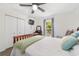 Nicely lit bedroom featuring wood floors, ceiling fan, and light walls and trim at 3880 Sw 6Th Ave, Ocala, FL 34471