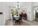 Cozy dining area with charming chandelier, table for four, and view to the outdoors at 3880 Sw 6Th Ave, Ocala, FL 34471