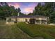 Charming single story home featuring a well manicured lawn, mature trees, and neutral color palette at 3880 Sw 6Th Ave, Ocala, FL 34471