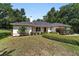 Inviting single-story home with a well-maintained lawn, manicured shrubs, and a welcoming entrance at 3880 Sw 6Th Ave, Ocala, FL 34471