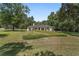 Serene front view of a home with a lush lawn, mature trees, and well-maintained landscaping, creating a welcoming ambiance at 3880 Sw 6Th Ave, Ocala, FL 34471