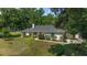 Attractive single-story home with a lush front yard, mature trees, and manicured landscaping, offering a peaceful setting at 3880 Sw 6Th Ave, Ocala, FL 34471