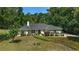 Well-maintained home featuring a lush front lawn, mature trees, and manicured landscaping, adding to its charm at 3880 Sw 6Th Ave, Ocala, FL 34471