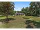 Charming single-story home features a lush green lawn and mature trees at 3880 Sw 6Th Ave, Ocala, FL 34471