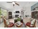 Bright living room featuring white brick fireplace, light wood floors, and comfortable seating at 3880 Sw 6Th Ave, Ocala, FL 34471