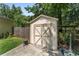 Charming storage shed with double doors, surrounded by greenery, providing practical outdoor storage space at 3880 Sw 6Th Ave, Ocala, FL 34471