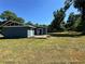 Exterior view of a blue home with a wooden deck, perfect for outdoor entertaining and relaxation at 4000 Sw 6Th Ave, Ocala, FL 34471