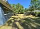 Large backyard with green grass and shady trees offers ample space for outdoor activities at 4000 Sw 6Th Ave, Ocala, FL 34471