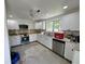 Renovated kitchen featuring new white cabinets, modern appliances, and stone countertops at 4000 Sw 6Th Ave, Ocala, FL 34471