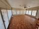 Bright sunroom with tile floors and multiple windows offering panoramic views of the outdoors at 4000 Sw 6Th Ave, Ocala, FL 34471