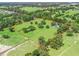 Aerial view of property highlighting mature trees, lush grounds, and the estate's boundary at 402 Sw 127Th Pl, Ocala, FL 34473