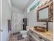 Bathroom features a vessel sink, decorative mirror, and shower with patterned curtain at 402 Sw 127Th Pl, Ocala, FL 34473