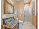 Charming bathroom featuring a glass bowl sink, granite countertop, and walk-in shower with decorative tile at 402 Sw 127Th Pl, Ocala, FL 34473