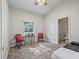 Cozy bedroom with seating area and doorway leading to bathroom with stacked washer/dryer at 402 Sw 127Th Pl, Ocala, FL 34473