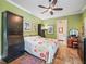 Bedroom with colorful bedspread, custom dresser, and an en-suite bathroom with a large soaking tub at 402 Sw 127Th Pl, Ocala, FL 34473