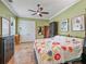 Bedroom with colorful bedspread, custom dresser, and double doors to the closet at 402 Sw 127Th Pl, Ocala, FL 34473