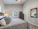 Comfortable bedroom with neutral walls, a floral bedspread, and natural light from the window at 402 Sw 127Th Pl, Ocala, FL 34473