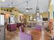 Open-concept dining area with a rustic table, statement lighting, and unique decorative accents at 402 Sw 127Th Pl, Ocala, FL 34473