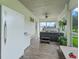 Enclosed patio featuring a hot tub, freezer, and mini fridge at 402 Sw 127Th Pl, Ocala, FL 34473