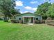 Charming home featuring a covered porch and well-maintained landscaping, under a partly cloudy blue sky at 402 Sw 127Th Pl, Ocala, FL 34473