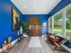 Bright blue foyer featuring an arched wooden door and wood-look flooring at 402 Sw 127Th Pl, Ocala, FL 34473