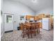 Eat-in kitchen area featuring wooden cabinets, granite countertops, and stainless steel appliances, next to the door at 402 Sw 127Th Pl, Ocala, FL 34473