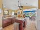 Bright kitchen features custom cabinets, marble countertops, and views to the outside patio and dining area at 402 Sw 127Th Pl, Ocala, FL 34473