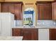 Kitchen sink with marble countertops and a large window overlooking a green pasture at 402 Sw 127Th Pl, Ocala, FL 34473