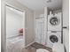 Compact laundry area conveniently located with a stacked washer and dryer next to the bathroom at 402 Sw 127Th Pl, Ocala, FL 34473