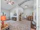 Open-concept living area featuring high ceilings, neutral walls, stylish furniture, and a view of the kitchen at 402 Sw 127Th Pl, Ocala, FL 34473