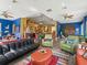 Bright, open living area featuring hardwood floors, colorful walls, and comfortable seating at 402 Sw 127Th Pl, Ocala, FL 34473