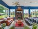 Cozy living room with a fireplace, colorful rug, and multiple sofas and chairs at 402 Sw 127Th Pl, Ocala, FL 34473