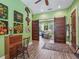Bright home office space boasts hardwood floors and sliding wood doors leading to a living room at 402 Sw 127Th Pl, Ocala, FL 34473