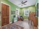 Bright home office space boasting hardwood floors, a ceiling fan and two windows providing natural light at 402 Sw 127Th Pl, Ocala, FL 34473