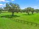 Lush green pasture with perimeter fencing and mature shade trees throughout at 402 Sw 127Th Pl, Ocala, FL 34473