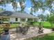 Outdoor patio with dining set perfect for entertaining, surrounded by lush greenery and well-kept landscaping at 402 Sw 127Th Pl, Ocala, FL 34473