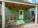 Inviting covered porch with seating, potted plants, and a white door and trim, enhancing curb appeal at 402 Sw 127Th Pl, Ocala, FL 34473