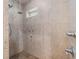 Shower with multiple shower heads, decorative wall tile, and transom window for natural light at 402 Sw 127Th Pl, Ocala, FL 34473