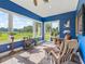 Light-filled sunroom with expansive windows overlooking a scenic pasture and comfortable seating at 402 Sw 127Th Pl, Ocala, FL 34473
