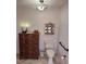 Traditional bathroom with wood dresser, decorative shelving unit and tiled floors at 4305 Sw 20Th Ave, Ocala, FL 34471