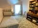 Bedroom with carpeting, bookshelves, and natural light from window at 4305 Sw 20Th Ave, Ocala, FL 34471