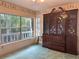 Bedroom featuring a large window with view of trees and an antique armoire with drawers at 4305 Sw 20Th Ave, Ocala, FL 34471