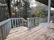 Outdoor deck overlooking wooded backyard. Table and chairs are present on the deck at 4305 Sw 20Th Ave, Ocala, FL 34471