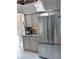 Kitchen featuring stainless steel refrigerator, appliances, granite counters, and light wood cabinets at 4305 Sw 20Th Ave, Ocala, FL 34471