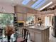 Open kitchen with an island, granite countertops, and a dining area at 4305 Sw 20Th Ave, Ocala, FL 34471