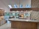 Spacious kitchen featuring granite countertops, a skylight, and modern appliances at 4305 Sw 20Th Ave, Ocala, FL 34471