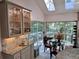 Bright kitchen with dining area, granite countertops, and glass-front cabinets at 4305 Sw 20Th Ave, Ocala, FL 34471