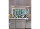 Kitchen sink with granite countertop and bay window overlooking the private backyard at 4305 Sw 20Th Ave, Ocala, FL 34471
